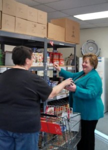 Wanda helps a client select food items at the pantry
