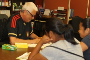 Phil works with two adult students at the Esperanza Center