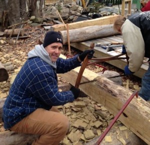 Ignatian Volunteer Greg Howes works on a building project with a resident of Dismas Family Farm.  They used hand tools to cut trees, saw them into logs, and chisel and create signs for the Worcester County Land Trust.