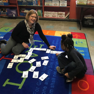 Jean and student participate in a game.