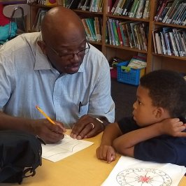 About-Mission IVC Volunteer working on child-friendly activities